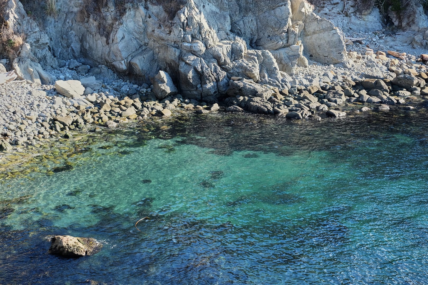 Rocky shoreline and blue green bay at Gerstle Cove Salt Point State Park